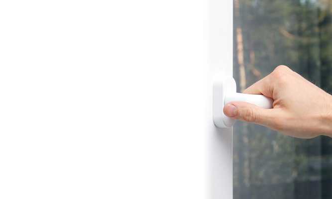 Zoomed in on door handle and hand opening Door with Sunglo Window Film